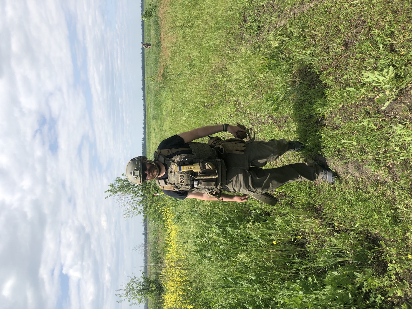Michael Monty Montoya wearing protective equipment on farmland in Kharkiv Oblast